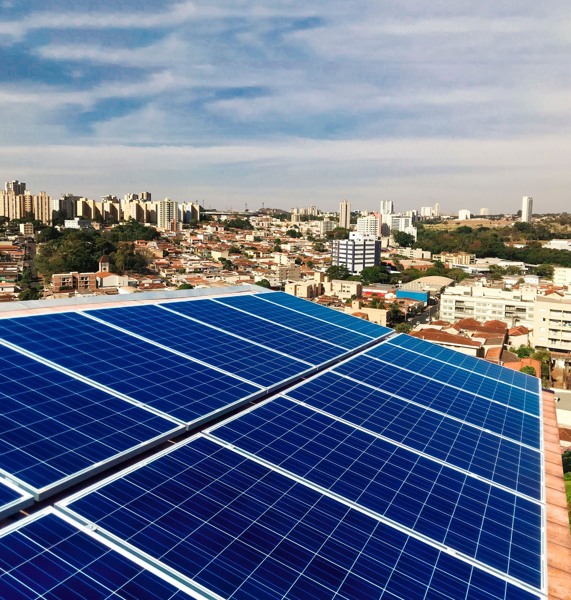 Photovoltaic power plant on the roof of a residential building on sunny day